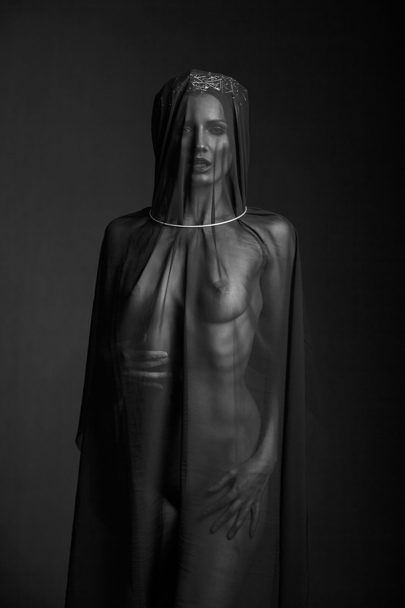 Nude fashion portrait of girl in a black shroud safety pin crown and metal collar fashion photographer Melbourne